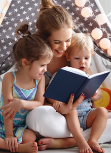 Mother with two children reading a book