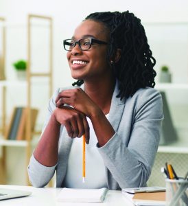 Business Career Concept. Afro Businesswoman Smiling Sitting In Modern Office. Copy Space